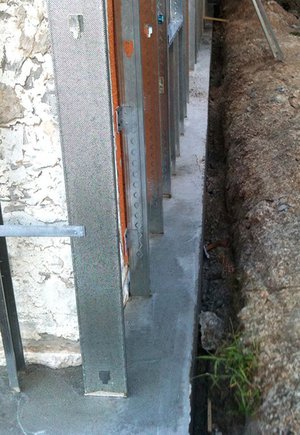 Cast galvanized steel panels in footing extension Cast galvanized steel panels in footing extension